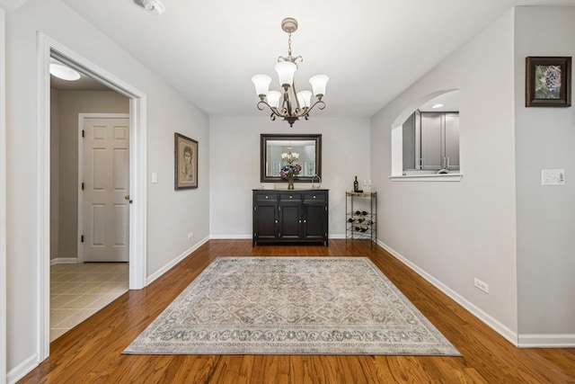 6173 Dixon Dr, Lisle, IL 60532 - entrance foyer featuring wood finished floors, a chandelier, and baseboards