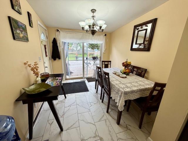 431 Edward St, Sycamore, IL 60178 - dining space with a chandelier and light marble finish floors
