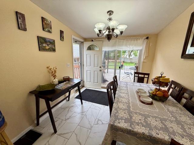 431 Edward St, Sycamore, IL 60178 - dining room featuring light marble finish floors, plenty of natural light, and a chandelier