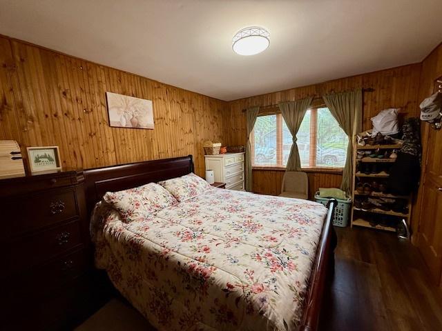 431 Edward St, Sycamore, IL 60178 - bedroom with wood walls and dark wood-style flooring