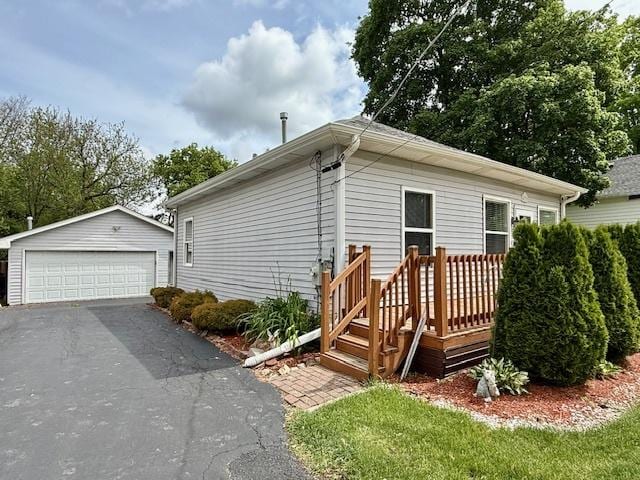 431 Edward St, Sycamore, IL 60178 - view of front of house featuring a garage, an outbuilding, and a wooden deck