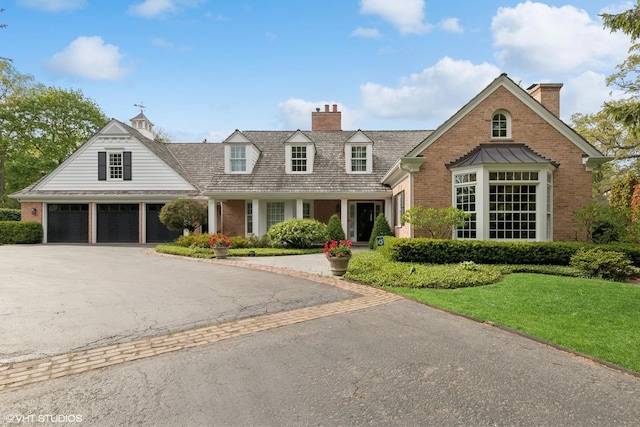 770 E Westminster Rd, Lake Forest, IL 60045 - view of front of property featuring a chimney, brick siding, asphalt driveway, and a front lawn
