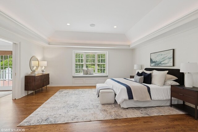 770 E Westminster Rd, Lake Forest, IL 60045 - bedroom featuring a tray ceiling, multiple windows, wood finished floors, ornamental molding, and access to exterior