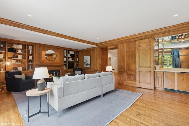 770 E Westminster Rd, Lake Forest, IL 60045 - living room with wooden walls, a lit fireplace, light wood finished floors, and built in features