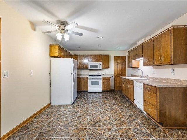 4560 Centerville Rd, Rockford, IL 61102 - kitchen with white appliances, ceiling fan, brown cabinets, and light countertops