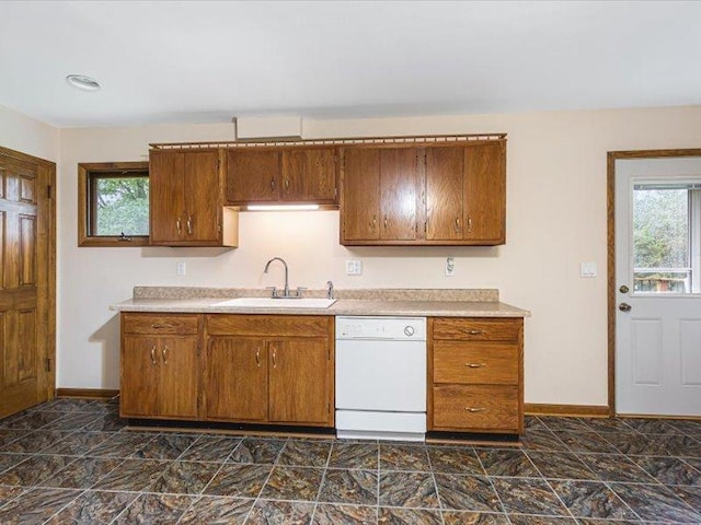 4560 Centerville Rd, Rockford, IL 61102 - kitchen featuring white dishwasher, a sink, baseboards, and brown cabinetry