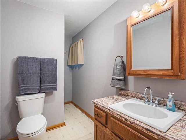 4560 Centerville Rd, Rockford, IL 61102 - bathroom featuring baseboards, tile patterned floors, toilet, and vanity