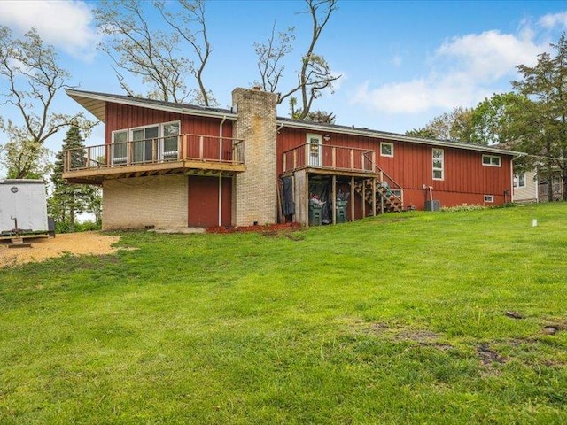4560 Centerville Rd, Rockford, IL 61102 - back of property with a chimney, a deck, a yard, and stairway
