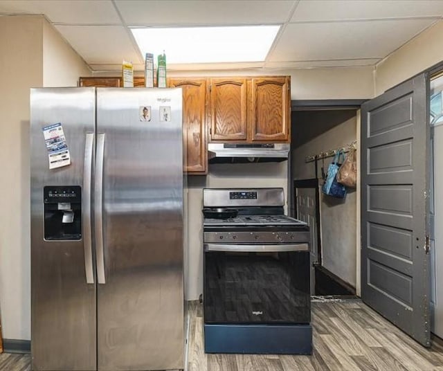 4560 Centerville Rd, Rockford, IL 61102 - kitchen with appliances with stainless steel finishes, under cabinet range hood, light wood finished floors, a drop ceiling, and brown cabinets