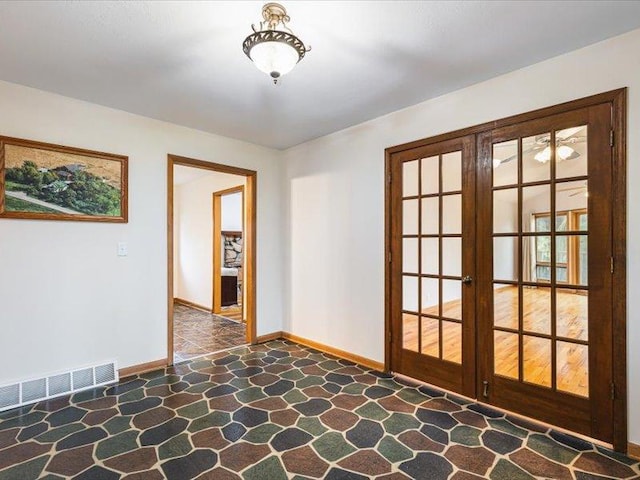 4560 Centerville Rd, Rockford, IL 61102 - spare room featuring stone floors, french doors, and baseboards
