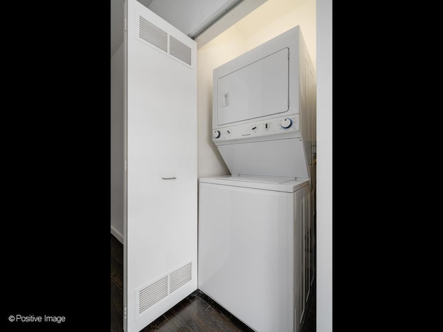 630 N Franklin St Unit 817, Chicago, IL 60654 - laundry room with stacked washing machine and dryer and a heating unit