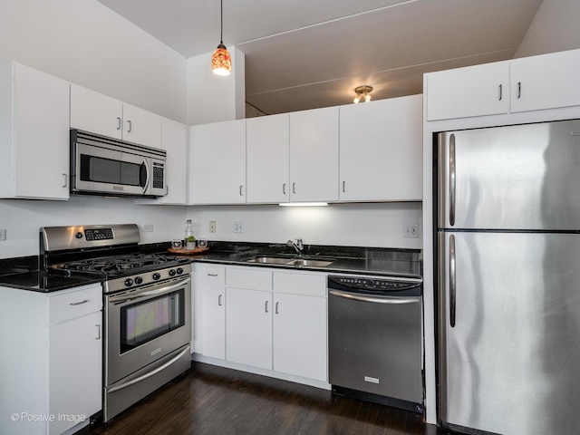 630 N Franklin St Unit 817, Chicago, IL 60654 - kitchen featuring stainless steel appliances, dark countertops, a sink, and dark wood-style flooring