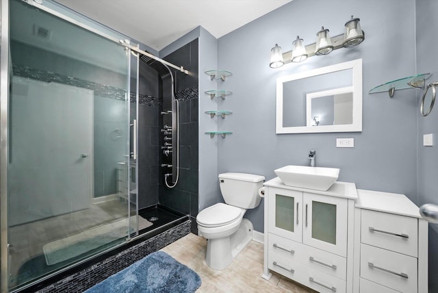 1516 S Wabash Ave Unit 306, Chicago, IL 60605 - full bathroom featuring toilet, a shower stall, vanity, baseboards, and wood finished floors