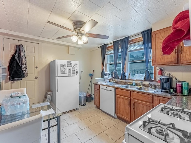 2531 N Lotus Ave, Chicago, IL 60639 - kitchen featuring white appliances, a sink, brown cabinets, and a ceiling fan