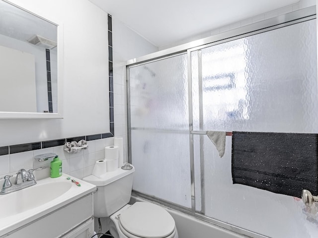 2531 N Lotus Ave, Chicago, IL 60639 - bathroom with vanity, toilet, tile walls, and enclosed tub / shower combo