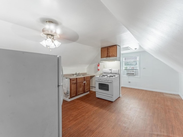 2531 N Lotus Ave, Chicago, IL 60639 - kitchen with freestanding refrigerator, white gas range oven, under cabinet range hood, a sink, and wood finished floors