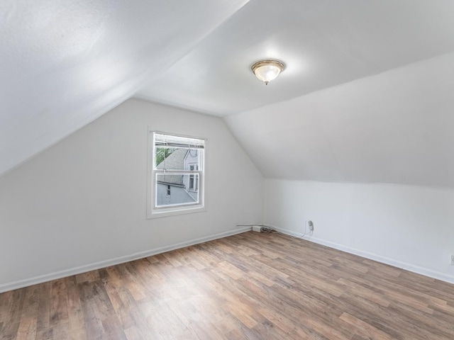 2531 N Lotus Ave, Chicago, IL 60639 - bonus room featuring wood finished floors, vaulted ceiling, and baseboards