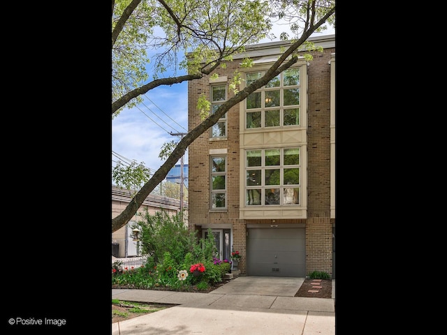 2393 N Wayne Ave, Chicago, IL 60614 - view of front of property featuring brick siding, concrete driveway, and an attached garage