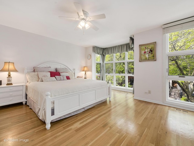 2393 N Wayne Ave, Chicago, IL 60614 - bedroom with multiple windows, light wood-type flooring, and ceiling fan