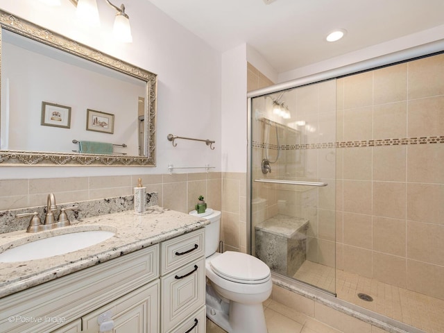 2393 N Wayne Ave, Chicago, IL 60614 - bathroom featuring vanity, a stall shower, toilet, tile walls, and tile patterned floors