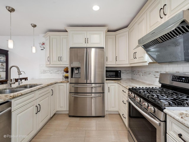 2393 N Wayne Ave, Chicago, IL 60614 - kitchen featuring appliances with stainless steel finishes, a sink, under cabinet range hood, tasteful backsplash, and light stone counters