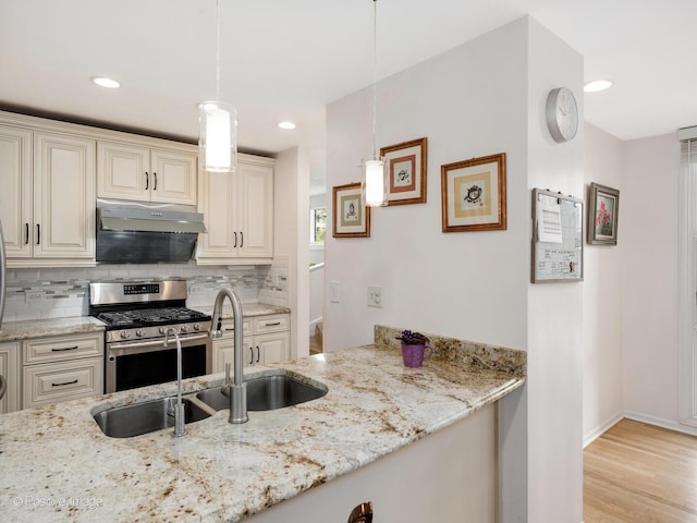 2393 N Wayne Ave, Chicago, IL 60614 - kitchen featuring stainless steel range with gas cooktop, tasteful backsplash, light stone counters, and recessed lighting
