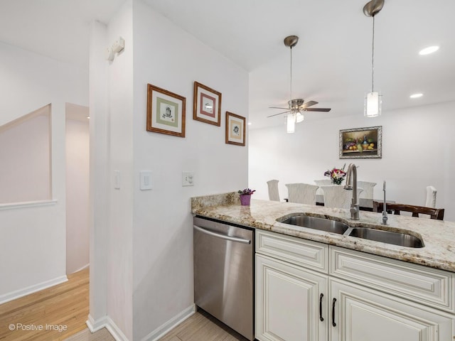 2393 N Wayne Ave, Chicago, IL 60614 - kitchen with stainless steel dishwasher, a sink, a ceiling fan, light stone counters, and light wood-type flooring