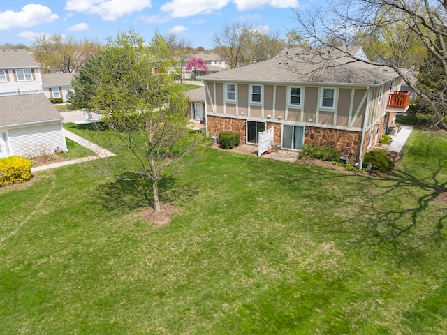 259 Nantucket Hbr Unit 259, Schaumburg, IL 60193 - back of property featuring stone siding, a shingled roof, stucco siding, and a yard