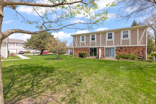 259 Nantucket Hbr Unit 259, Schaumburg, IL 60193 - back of property with stucco siding, stone siding, and a yard