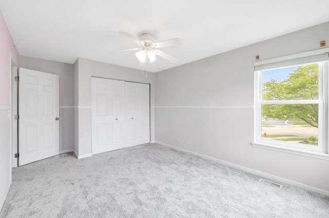 675 Fieldcrest Dr Unit 1A, South Elgin, IL 60177 - unfurnished bedroom featuring carpet floors, baseboards, a closet, and a ceiling fan