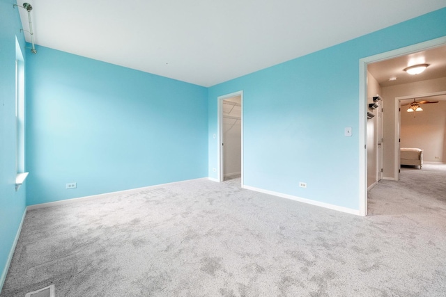 675 Fieldcrest Dr Unit 1A, South Elgin, IL 60177 - spare room featuring carpet flooring, baseboards, and a ceiling fan