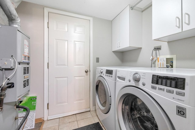 675 Fieldcrest Dr Unit 1A, South Elgin, IL 60177 - washroom featuring washer and dryer, cabinet space, light tile patterned floors, and baseboards