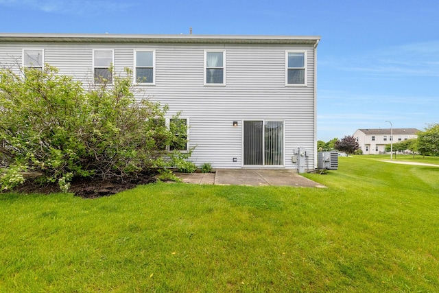 675 Fieldcrest Dr Unit 1A, South Elgin, IL 60177 - rear view of house featuring a patio, a yard, and central air condition unit