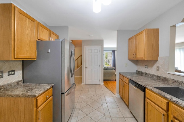 675 Fieldcrest Dr Unit 1A, South Elgin, IL 60177 - kitchen featuring appliances with stainless steel finishes, healthy amount of natural light, decorative backsplash, and light tile patterned floors