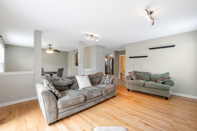 675 Fieldcrest Dr Unit 1A, South Elgin, IL 60177 - living area with rail lighting, light wood-style flooring, a ceiling fan, and baseboards