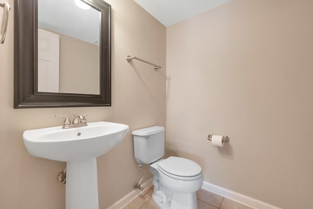 675 Fieldcrest Dr Unit 1A, South Elgin, IL 60177 - half bathroom featuring toilet, baseboards, tile patterned flooring, and a sink