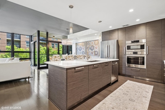 1018 N Larrabee St Unit 3S, Chicago, IL 60610 - kitchen featuring open floor plan, a sink, stainless steel appliances, modern cabinets, and light countertops
