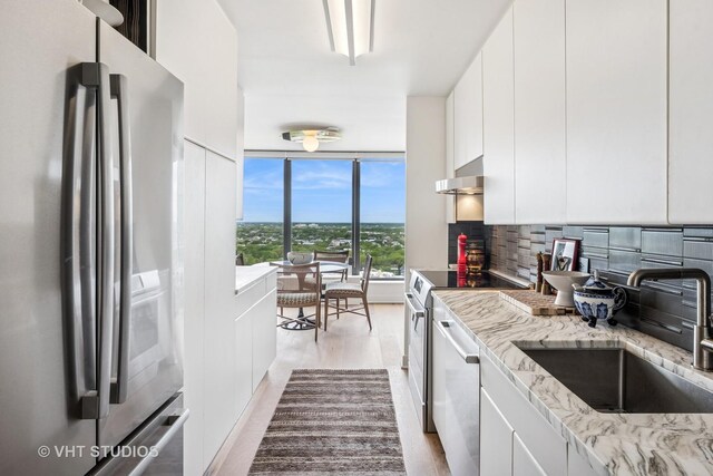 5445 N Sheridan Rd Unit 2715, Chicago, IL 60640 - kitchen with stainless steel refrigerator with ice dispenser, a sink, backsplash, modern cabinets, and white cabinetry