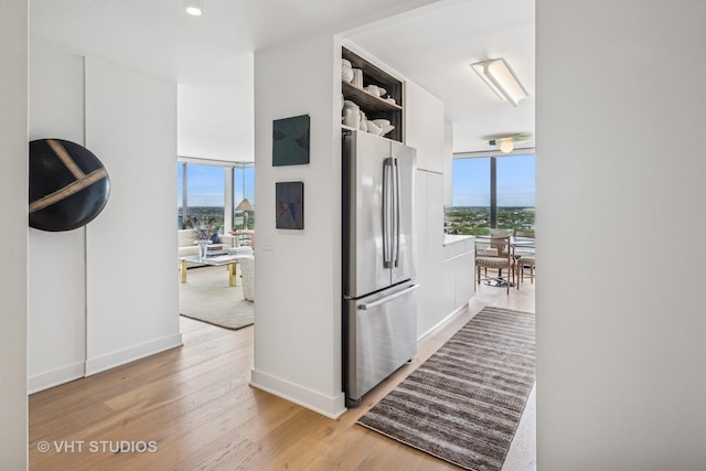 5445 N Sheridan Rd Unit 2715, Chicago, IL 60640 - corridor featuring plenty of natural light, light wood-style flooring, and baseboards