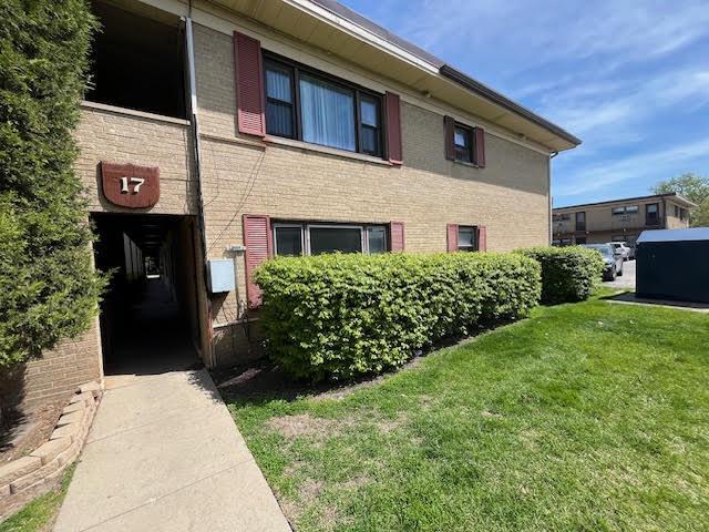 17 King Arthur Ct Unit 7, Northlake, IL 60164 - view of property exterior featuring a lawn and brick siding