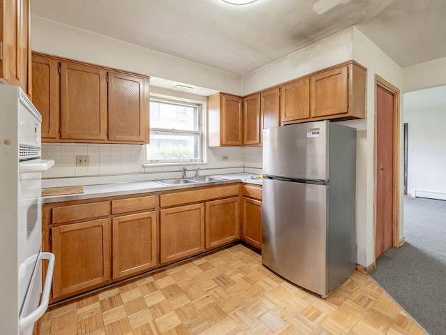 17 King Arthur Ct Unit 7, Northlake, IL 60164 - kitchen featuring freestanding refrigerator, a sink, light countertops, and tasteful backsplash