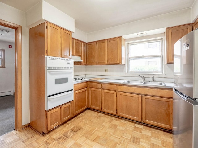 17 King Arthur Ct Unit 7, Northlake, IL 60164 - kitchen featuring white appliances, a warming drawer, a sink, decorative backsplash, and light countertops