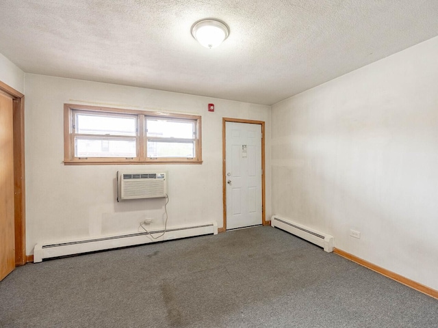 17 King Arthur Ct Unit 7, Northlake, IL 60164 - empty room with a baseboard radiator, carpet, a wall unit AC, a textured ceiling, and baseboards