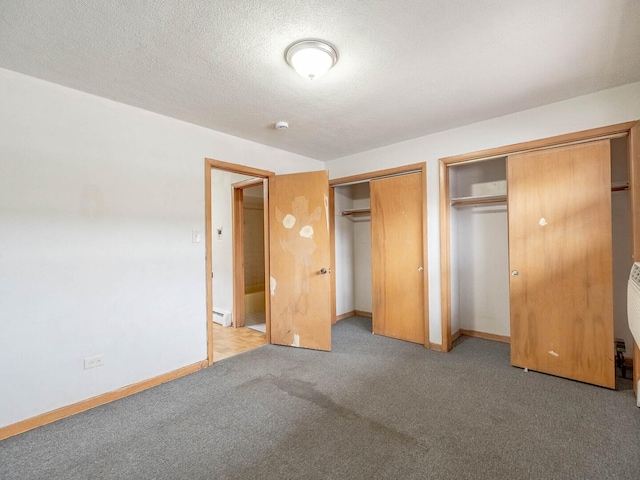17 King Arthur Ct Unit 7, Northlake, IL 60164 - unfurnished bedroom with two closets, carpet floors, baseboards, and a baseboard radiator