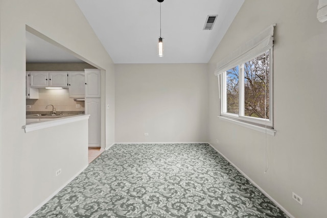 1406 Aldgate Ct Unit D2, Wheeling, IL 60090 - unfurnished dining area featuring lofted ceiling, a sink, light carpet, and baseboards