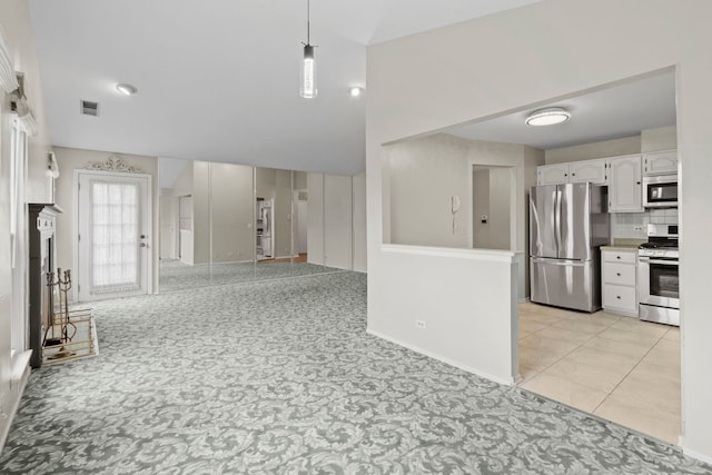 1406 Aldgate Ct Unit D2, Wheeling, IL 60090 - kitchen with stainless steel appliances, white cabinets, open floor plan, pendant lighting, and light colored carpet