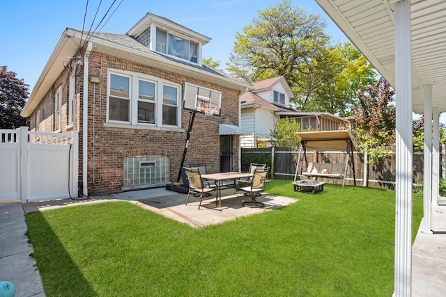 2403 Highland Ave, Berwyn, IL 60402 - back of house featuring brick siding, a patio, and a trampoline