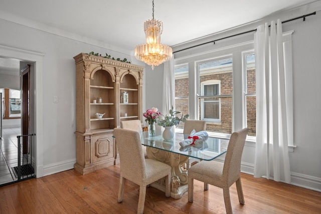 2403 Highland Ave, Berwyn, IL 60402 - dining area with light wood-style flooring, a chandelier, and baseboards