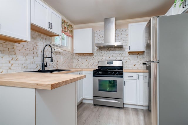 709 S Oak St, Bloomington, IL 61701 - kitchen featuring wood counters, stainless steel appliances, wall chimney range hood, a sink, and ornamental molding