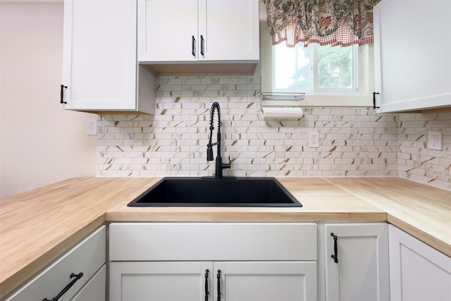 709 S Oak St, Bloomington, IL 61701 - kitchen with butcher block counters, a sink, and tasteful backsplash